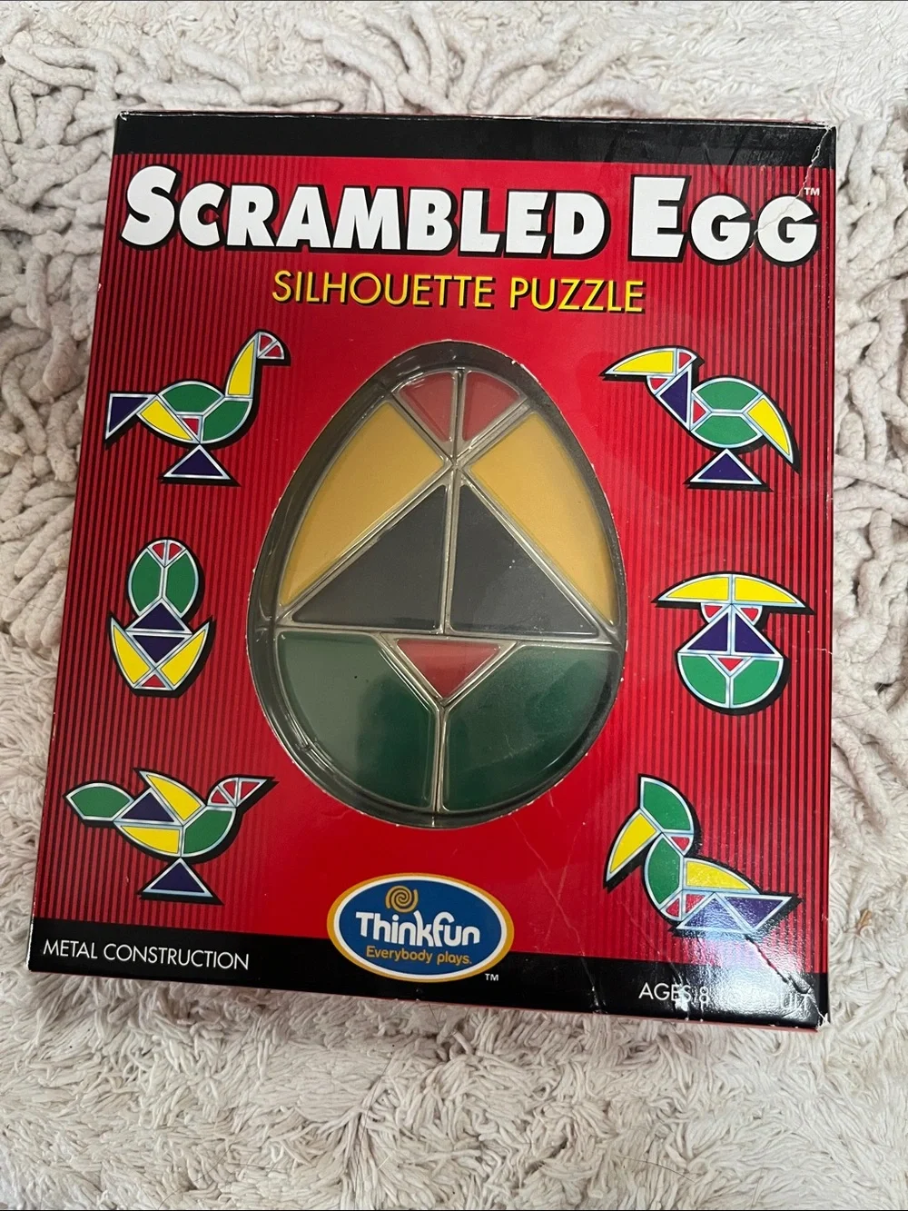 Scrambled Egg Silhouette Puzzle by ThinkFun - Red Box, Yellow/Green/Gray Pieces